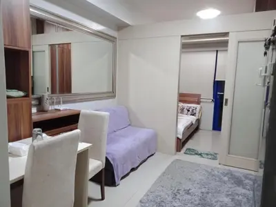 a small room with a bed and a desk and a bedroom at Jericho's Place in Manila