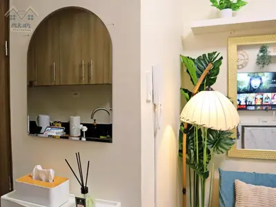 a kitchen with a sink and a mirror at Cozy Vibrant Staycation Netflix Wifi Mandaluyong in Manila