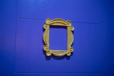 a gold picture of a mirror on a blue background at The One with Purple Apartment in Manila