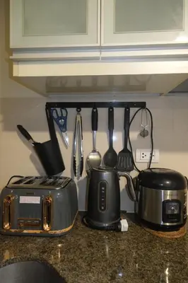 a kitchen counter with a toaster and a tea pot at Cluster 2, 81 Newport Blvd Near NAIA T3 in Manila