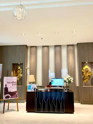 a woman sitting at a desk in a lobby at Cluster 2, 81 Newport Blvd Near NAIA T3 in Manila
