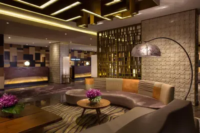 a hotel lobby with a couch and a table at City of Dreams - Nobu Hotel Manila in Manila