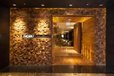 a lobby with a novo sign on a wall at City of Dreams - Nobu Hotel Manila in Manila