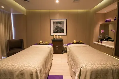 a hotel room with two beds and a sink at City of Dreams - Nobu Hotel Manila in Manila