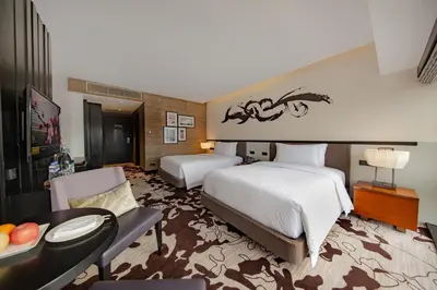 a hotel room with two beds and a living room at City of Dreams - Nobu Hotel Manila in Manila