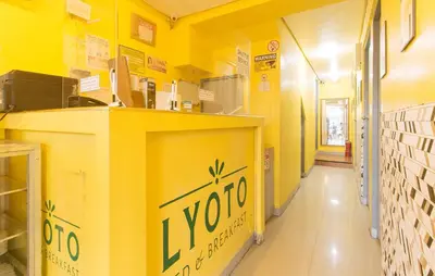 a yellow room with a yoda sign on the wall at RedDoorz at LYOTO Bed and Breakfast near NAIA Terminal in Manila