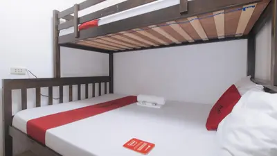 two bunk beds in a room with a ladder at RedDoorz at LYOTO Bed and Breakfast near NAIA Terminal in Manila