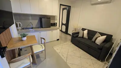 a small living room with a couch and a table at Flat 35, Unit D in Manila