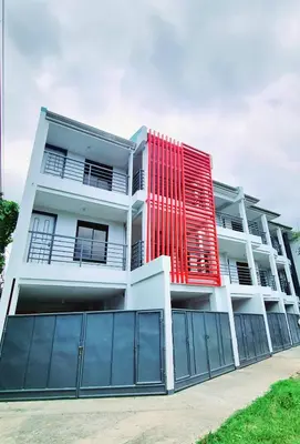 a white building with a red facade at Flat 35, Unit D in Manila