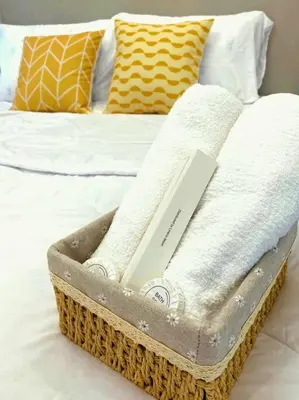 a wicker basket sitting on top of a bed at 1BR Balcony Luxury Condo Shore 2 Near MOA & NAIA in Manila