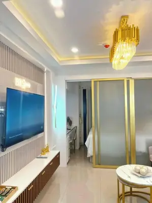 a living room with a large aquarium and a table at 1BR Balcony Luxury Condo Shore 2 Near MOA & NAIA in Manila