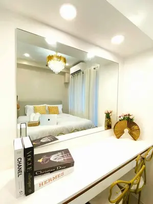 a room with two beds and a mirror at 1BR Balcony Luxury Condo Shore 2 Near MOA & NAIA in Manila