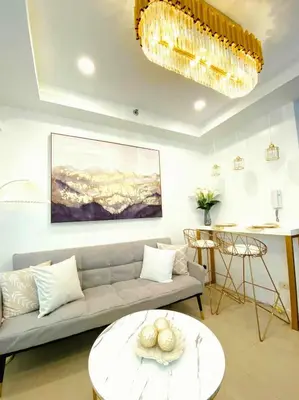 a living room with a couch and a table at 1BR Balcony Luxury Condo Shore 2 Near MOA & NAIA in Manila