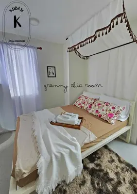 a bedroom with a bed with a tray on it at Vintage charm meets modern relaxation near Araneta in Manila