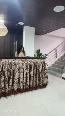 a woman sitting at a counter in a building at Vintage charm meets modern relaxation near Araneta in Manila