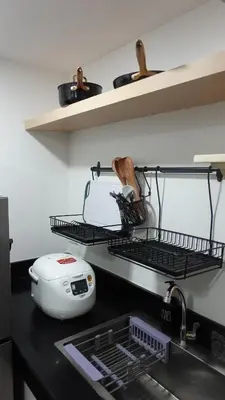 a kitchen counter with a sink and a toaster at Modern Condo for 6, with Kitchen, Wi-Fi & Netflix, Near MRT Boni in Manila