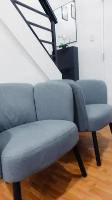 a blue couch and a chair in a room at Modern Condo for 6, with Kitchen, Wi-Fi & Netflix, Near MRT Boni in Manila