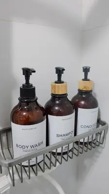 three bottles of body wash on a shelf at Modern Condo for 6, with Kitchen, Wi-Fi & Netflix, Near MRT Boni in Manila