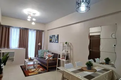 a living room with a couch and a table at 1BR with Balcony Condo accross NAIA T3 in Manila