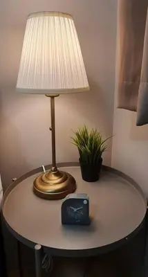a table with a lamp and a clock on it at 1BR with Balcony Condo accross NAIA T3 in Manila
