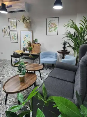 a living room with a couch and tables and plants at Playful comfort and Serene relaxation in Cubao in Manila