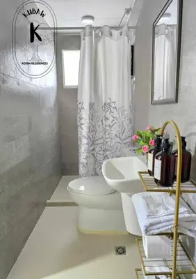 a bathroom with a toilet and a sink at Playful comfort and Serene relaxation in Cubao in Manila