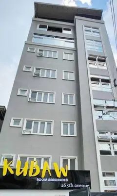a tall building with a sign on the side of it at Playful comfort and Serene relaxation in Cubao in Manila