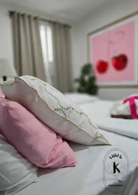 a bed with pink and white pillows on it at Playful comfort and Serene relaxation in Cubao in Manila