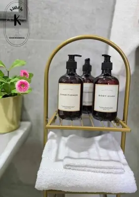 a rack with three bottles of soap on it in a bathroom at Playful comfort and Serene relaxation in Cubao in Manila