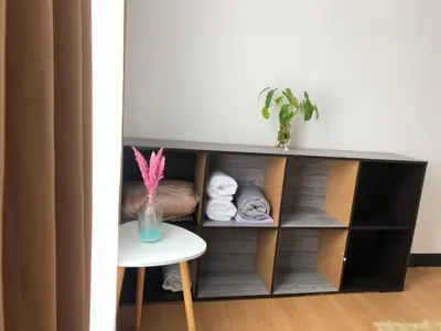 a black cabinet with a table and a vase at Metro Suites in Anabu Primero