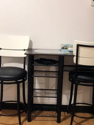 a desk with two chairs and a table with a table at Metro Suites in Anabu Primero