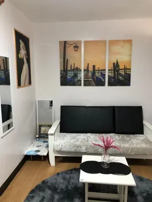 a living room with a couch and a table at Metro Suites in Anabu Primero