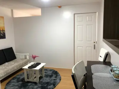 a living room with a couch and a table at Metro Suites in Anabu Primero