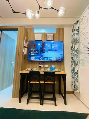 a desk in a room with a tv and a table at Coast Stay by J 41st floor Penthouse in Manila