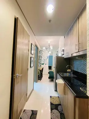 a kitchen with a sink and a door to a room at Coast Stay by J 41st floor Penthouse in Manila