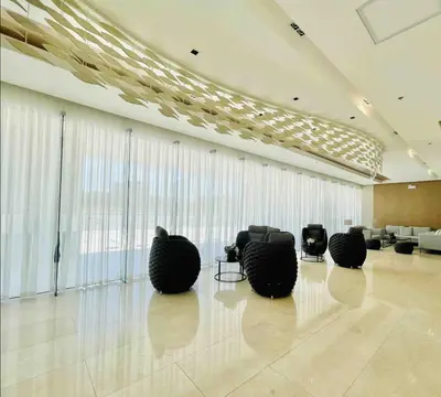 a lobby with black chairs in a room with windows at Near MOA Manila Bay Airport via NAIAX Balcony WiFi SHORE#3 Residences in Manila