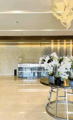 a lobby with a table with vases of flowers on it at Near MOA Manila Bay Airport via NAIAX Balcony WiFi SHORE#3 Residences in Manila