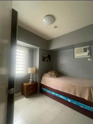 a bedroom with a bed with a fish tank on it at Avida San lorenzo Tower 1 in Manila
