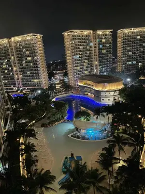 a view of a city at night with buildings at 1 Bedroom Azure Staycation Near NAIA in Manila
