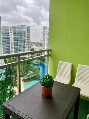 a table with a potted plant on a balcony at 1 Bedroom Azure Staycation Near NAIA in Manila