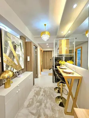 a kitchen with a table and a dining room at Skyport Luxe in Manila