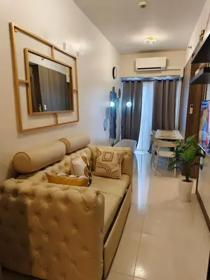 a living room with a couch and a table at City Serenity Escape in Manila