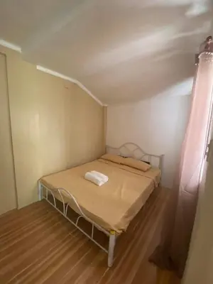 a small bedroom with a bed in a room at Cernardo's Staycation Place 1 near Enchanted Kingdom in Ibaba