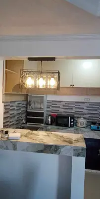 a kitchen with a counter top and a microwave at Cernardo's Staycation Place 1 near Enchanted Kingdom in Ibaba