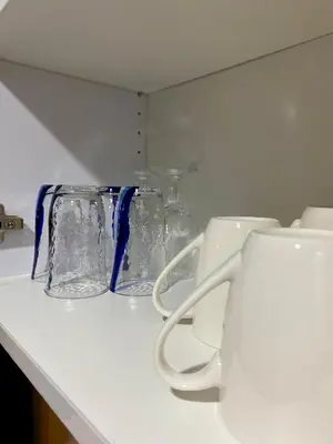 a row of glass vases sitting on a counter at Ikigai Charlie Makati Condo Premium Comfort & Luxury in Manila
