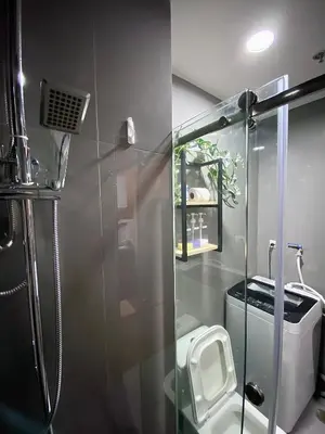 a bathroom with a glass shower with a toilet at Ikigai Charlie Makati Condo Premium Comfort & Luxury in Manila
