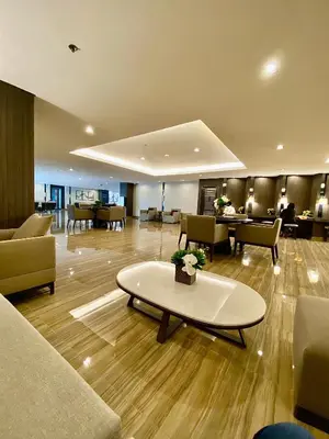a lobby with couches and chairs and a table at Ikigai Charlie Makati Condo Premium Comfort & Luxury in Manila