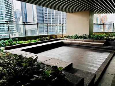 a building with benches and plants on a balcony at Ikigai Charlie Makati Condo Premium Comfort & Luxury in Manila