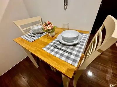 a dining room table with a checkered table cloth on it at Ikigai Delta Makati Condo Luxury Sunset View in Manila