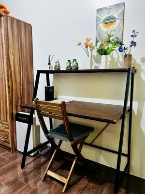 a desk with a chair and potted plants on it at Ikigai Delta Makati Condo Luxury Sunset View in Manila